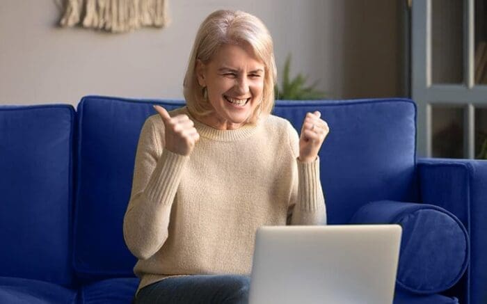 excited woman on laptop